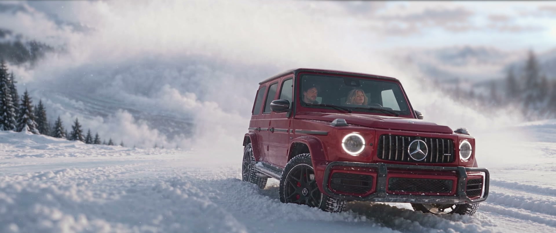 A burgundy Mercedes G-Class driving through snow in Polar Vortex